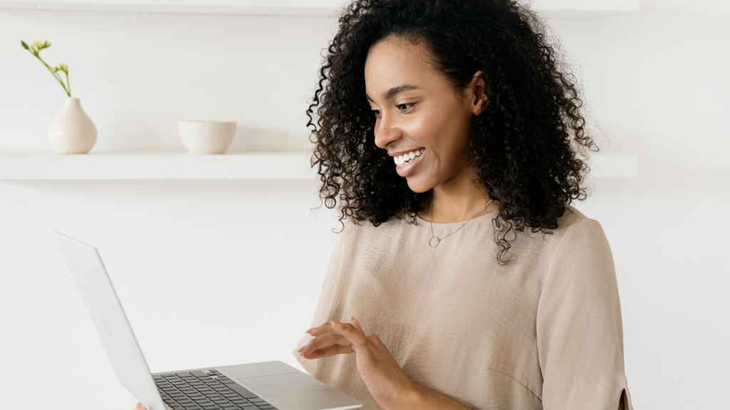 Girl working on laptop and smiling