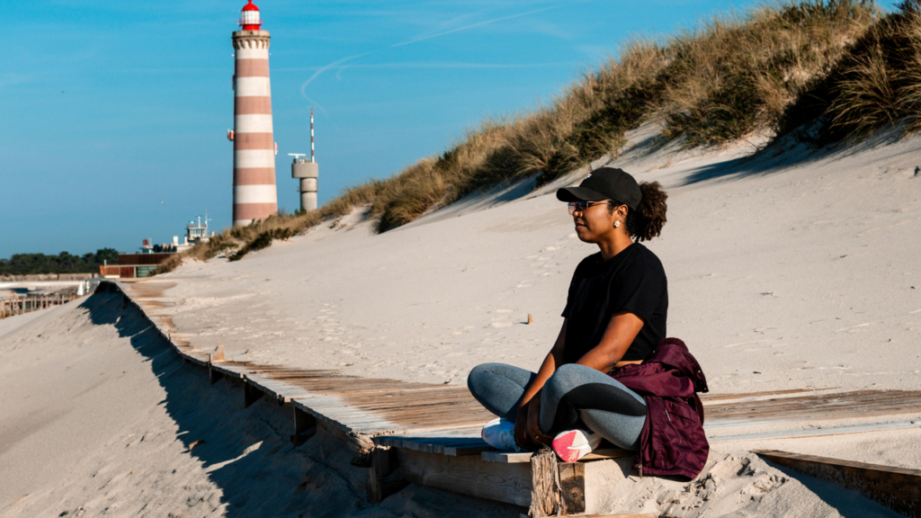 Woman sitting, thinking, reflecting, lighthouse