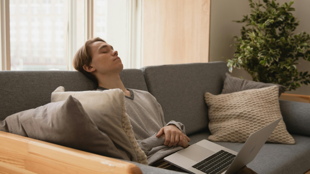 Young man taking a micro nap with laptop