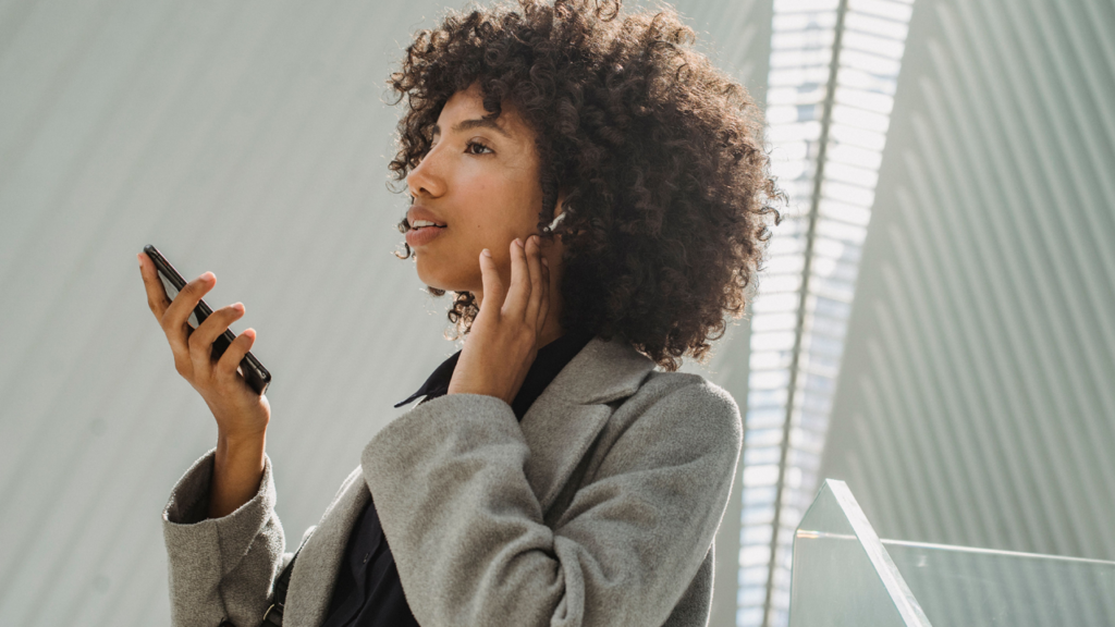 Woman using a phone for dictation