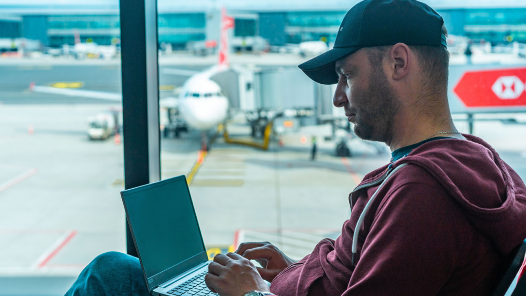Man using a laptop at the airport