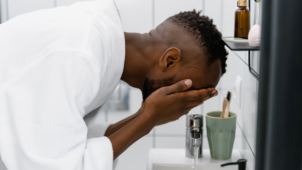 Man splashing water on his face