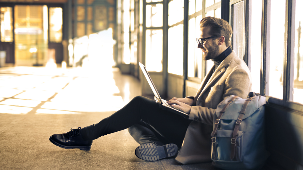 Man on laptop in an open space